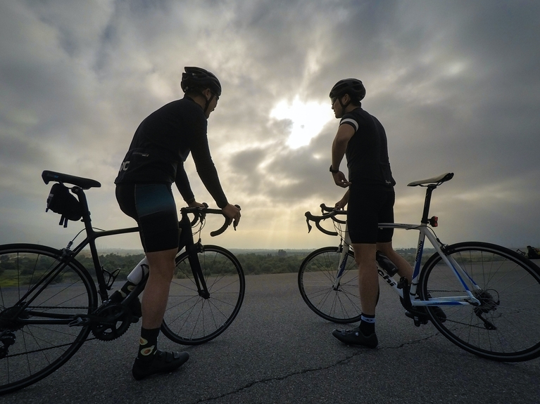 2 men biking at sunset | online personal training packages