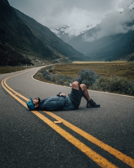 runner laying down on the street | is rest day important