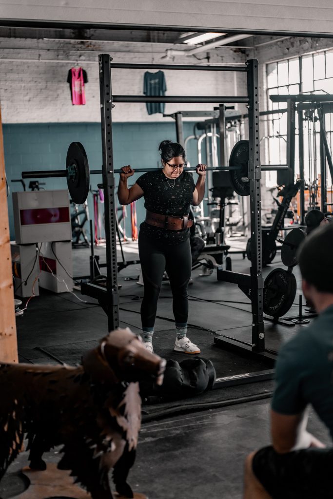 woman squatting with proper form for a power lifing competition